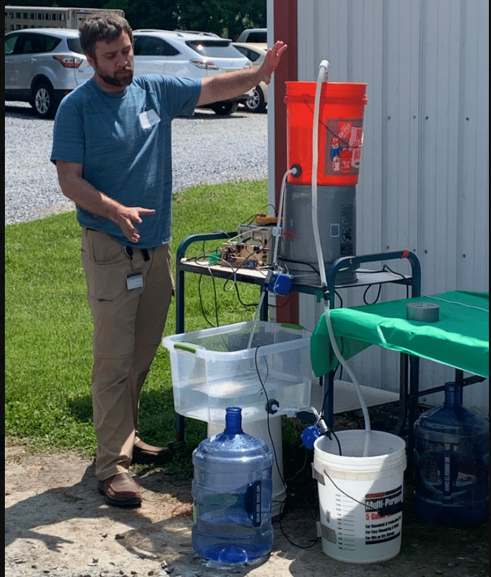 Brian Moyer demonstrates how researchers use the Tiny Integrated Diurnal Event Simulator (TIDES) to study saltwater intrusion in laboratory settings