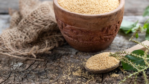 Raw Organic Amaranth Grain In A Bowl With Wooden Spoon